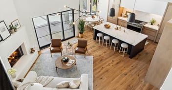 Open-concept living and kitchen area addition in Scottsdale AZ by Trinity Homes AZ featuring vaulted ceilings and marble island