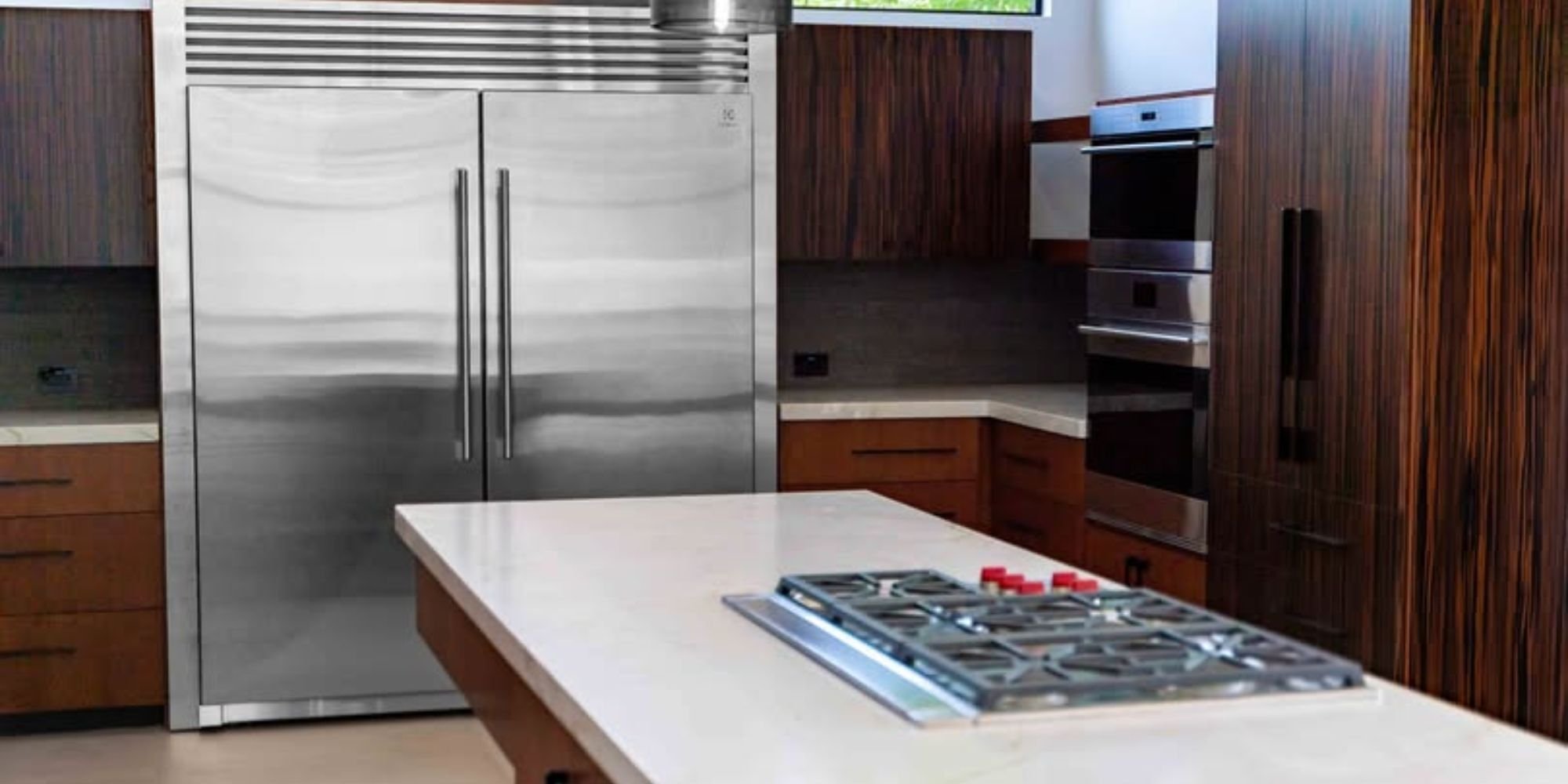 High-end kitchen design by Trinity Homes AZ in Scottsdale AZ featuring a built-in gas cooktop and wood cabinetry