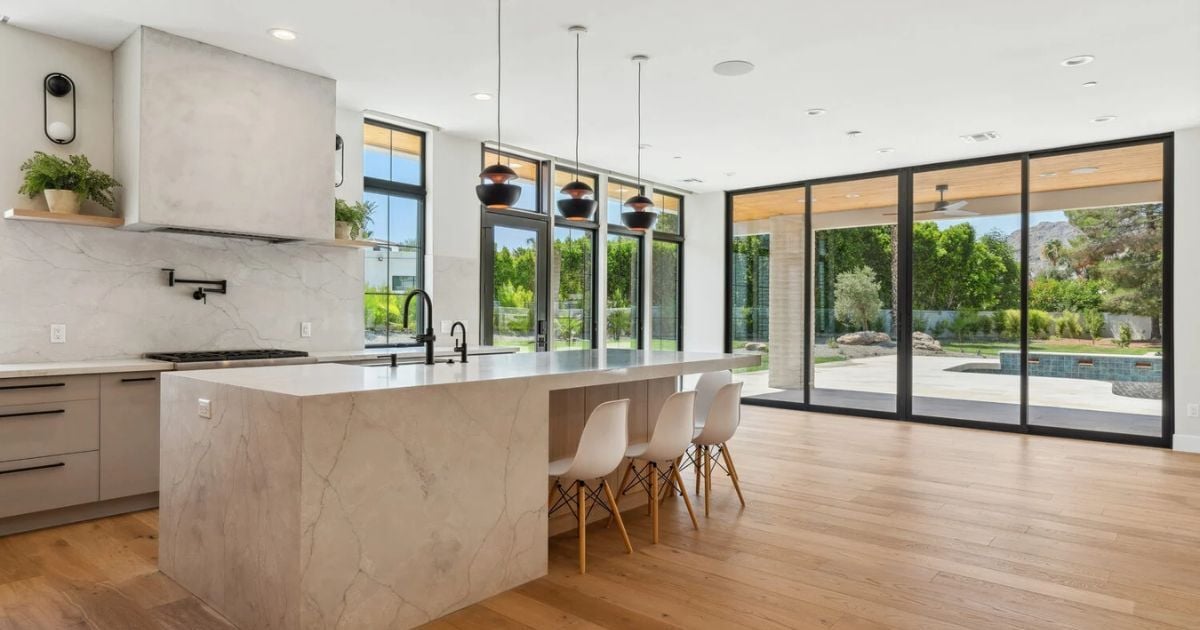 Spacious Arizona kitchen remodel by Trinity Homes featuring quartz island and sliding glass doors
