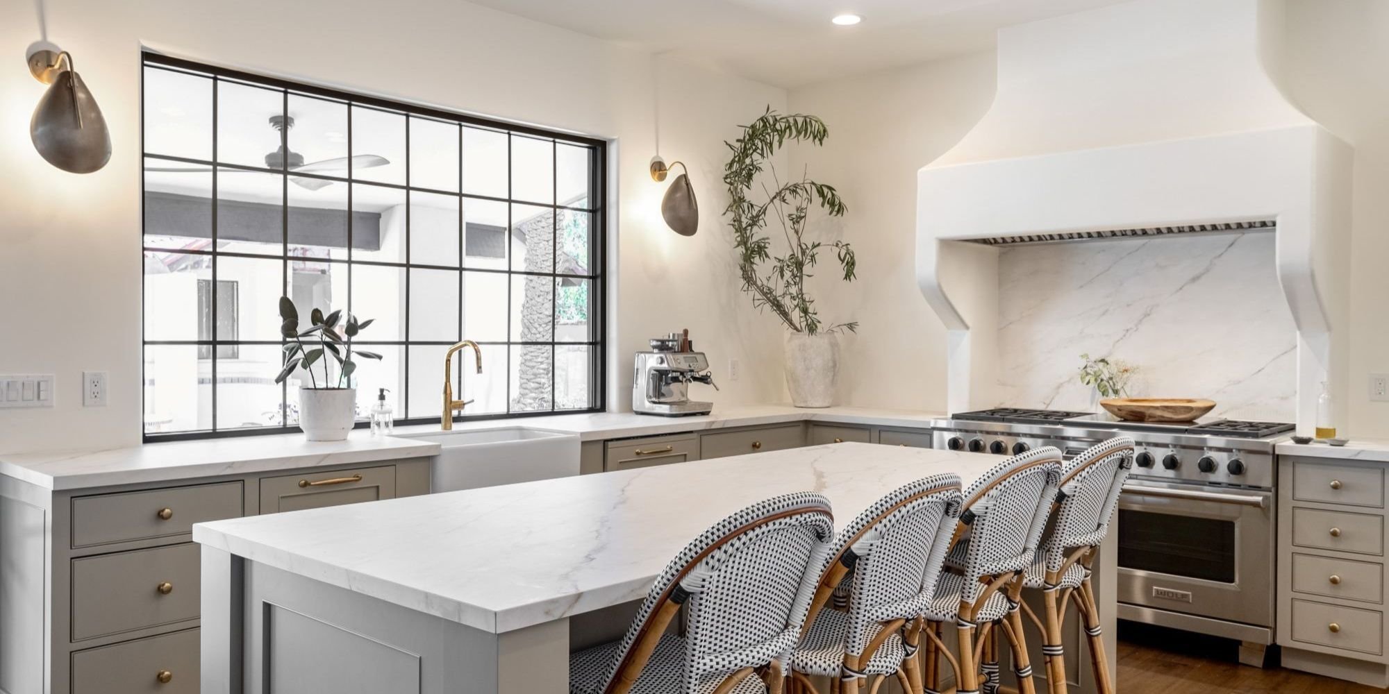 Trinity Homes Arizona kitchen remodel with marble island, farmhouse sink, and custom range hood
