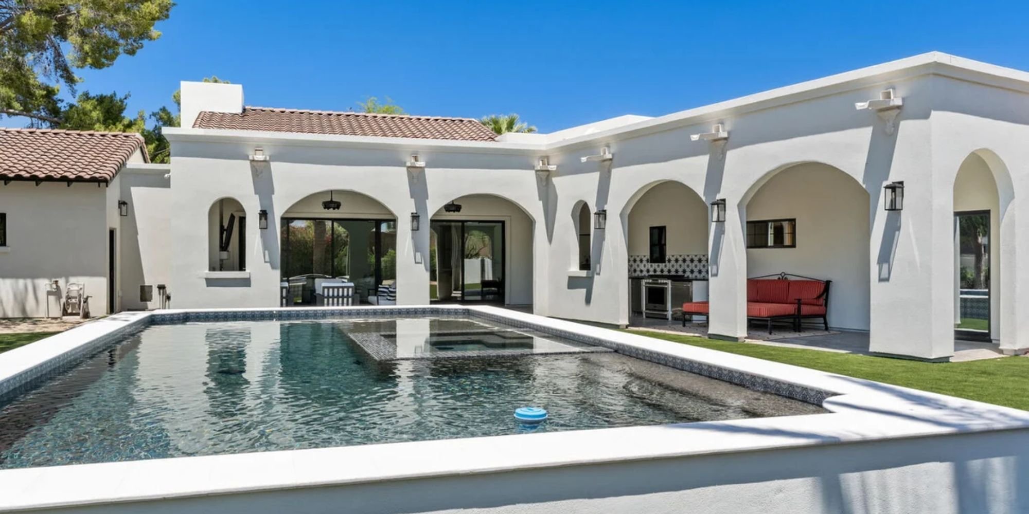 Custom Arizona home by Trinity Homes featuring arched patio and luxury pool design