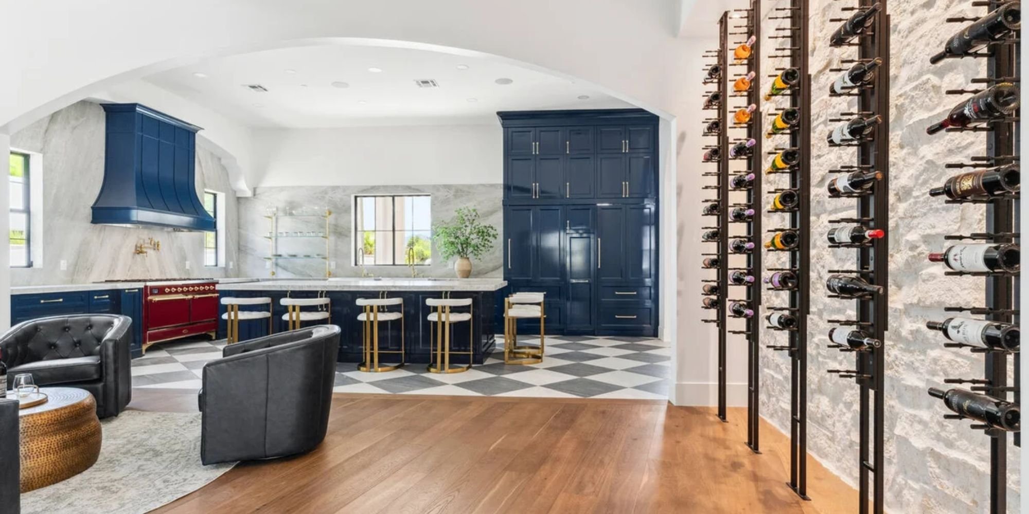 Custom Arizona home by Trinity Homes featuring bold blue kitchen and modern wine wall