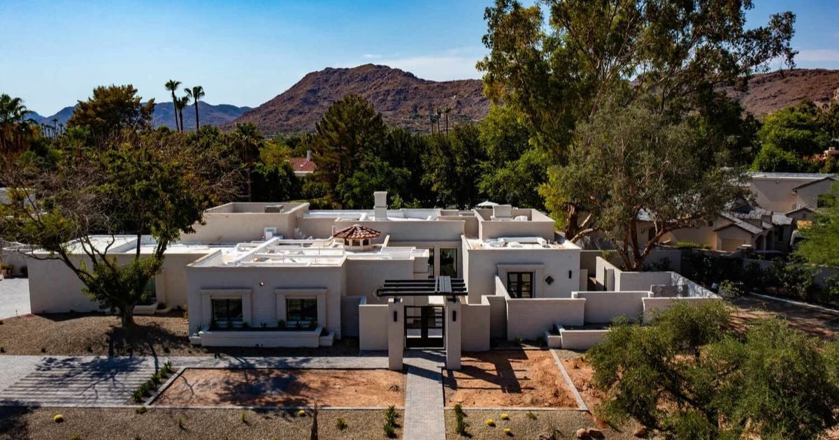 Trinity Homes custom residence in Arizona featuring white stucco exterior and bold entryway