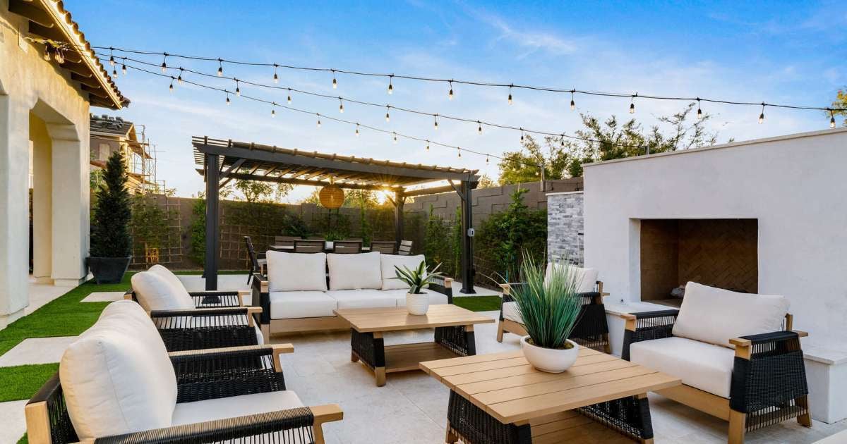 Outdoor living space with fireplace and plenty of seating by Trinity Homes AZ in Scottsdale, AZ