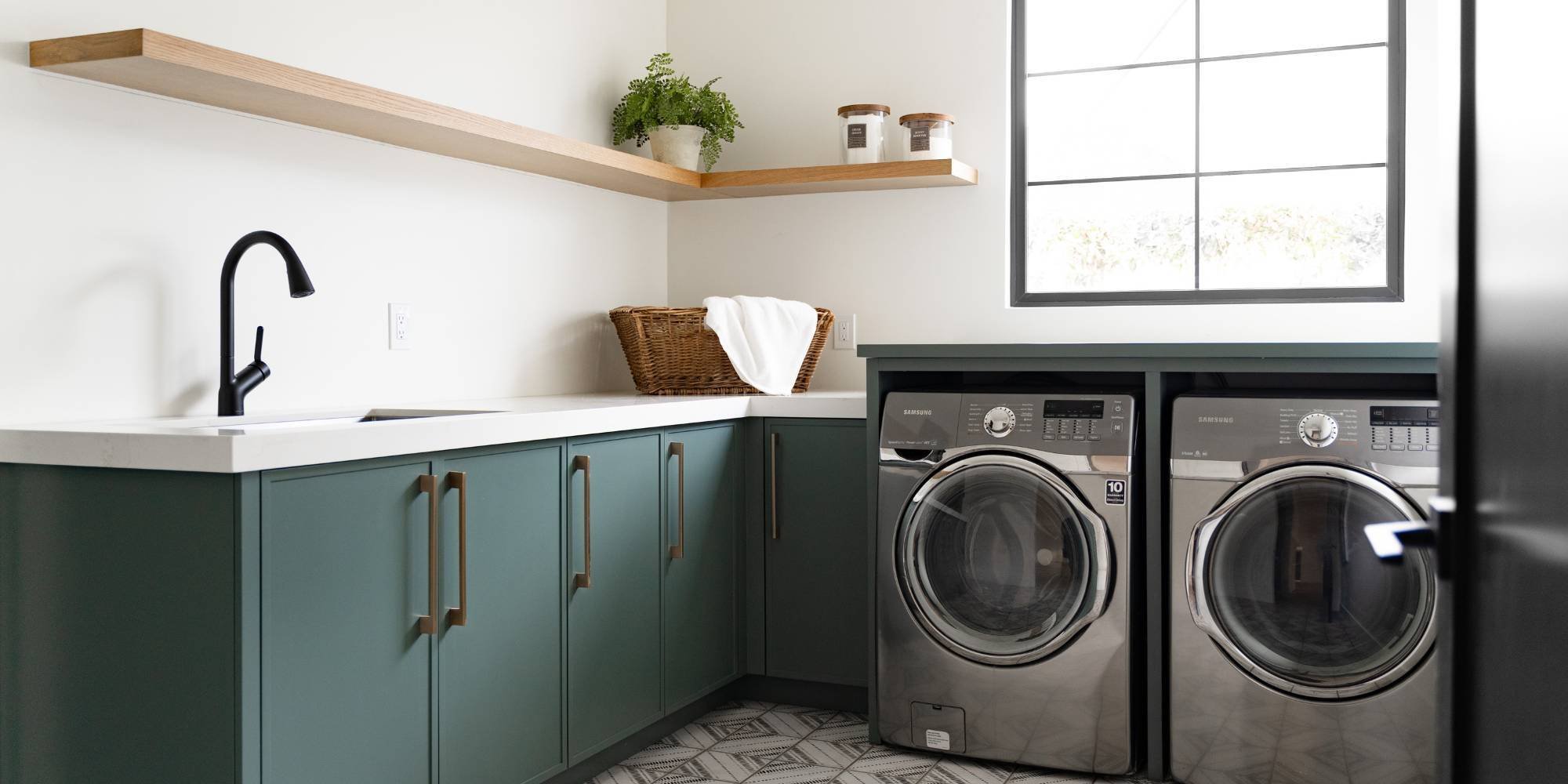 Custom laundry room remodel with stylish cabinetry, utility sink, and upgraded appliances by Trinity Homes