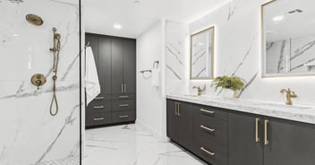 Luxury bathroom remodel in Scottsdale, AZ with marble shower, double vanity, and gold fixtures