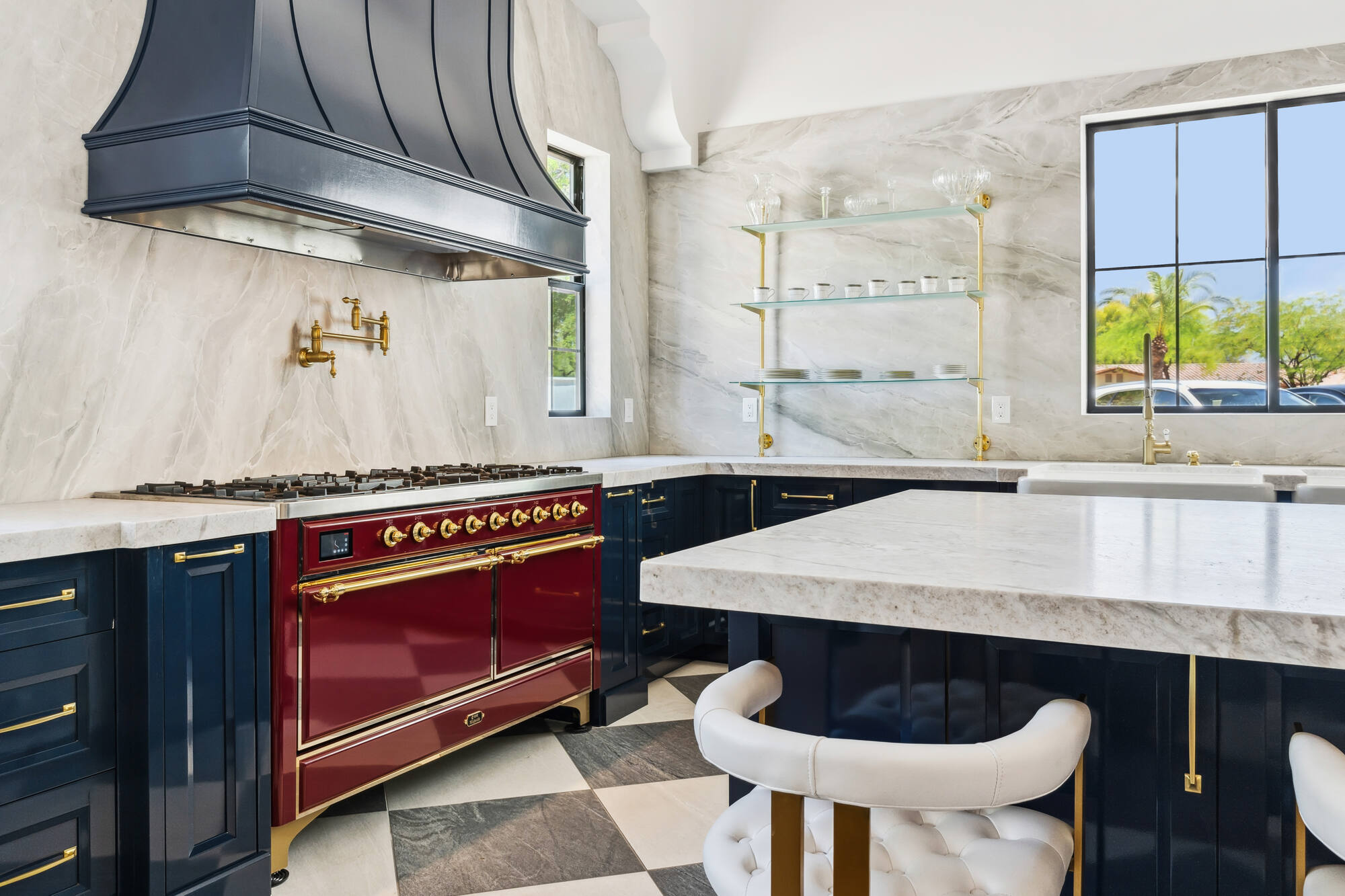 Corner view of custom kitchen with floating shelves and red stove in Scottsdale home by Trinity Homes