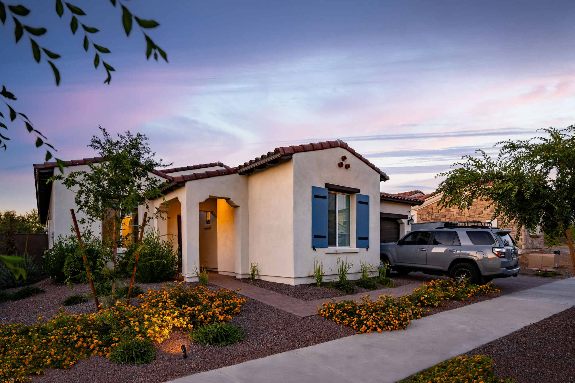 Full exterior view of remodeled Phoenix home with landscaping and driveway by Trinity Homes