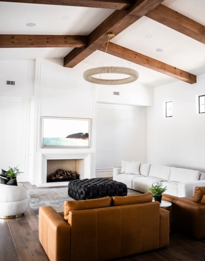 Modern living room with wood beams and fireplace in Trinity Homes’ whole home remodel in Scottsdale, AZ-1