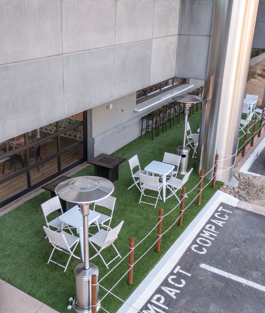 Outdoor space with tables and turf grass at a commercial building in Scottsdale, AZ Outdoor space with tables and turf grass at a commercial building in Scottsdale, AZ