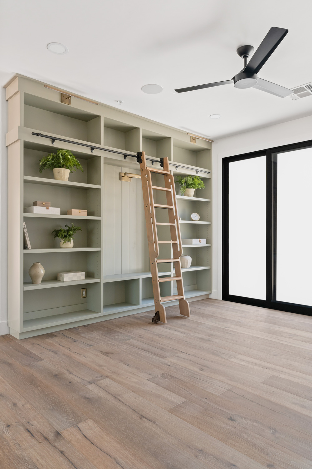 Library space with built-in cabinetry and sliding ladder in Scottsdale, AZ, home Library space with built-in cabinetry and sliding ladder in Scottsdale, AZ, home