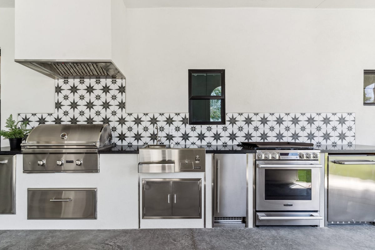 Built-in grill and sink with decorative tile, part of Trinity Homes’ whole home remodel in Phoenix, AZ