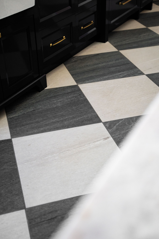 Checkered tile flooring beside dark cabinetry in Trinity Homes Scottsdale, AZ kitchen remodel