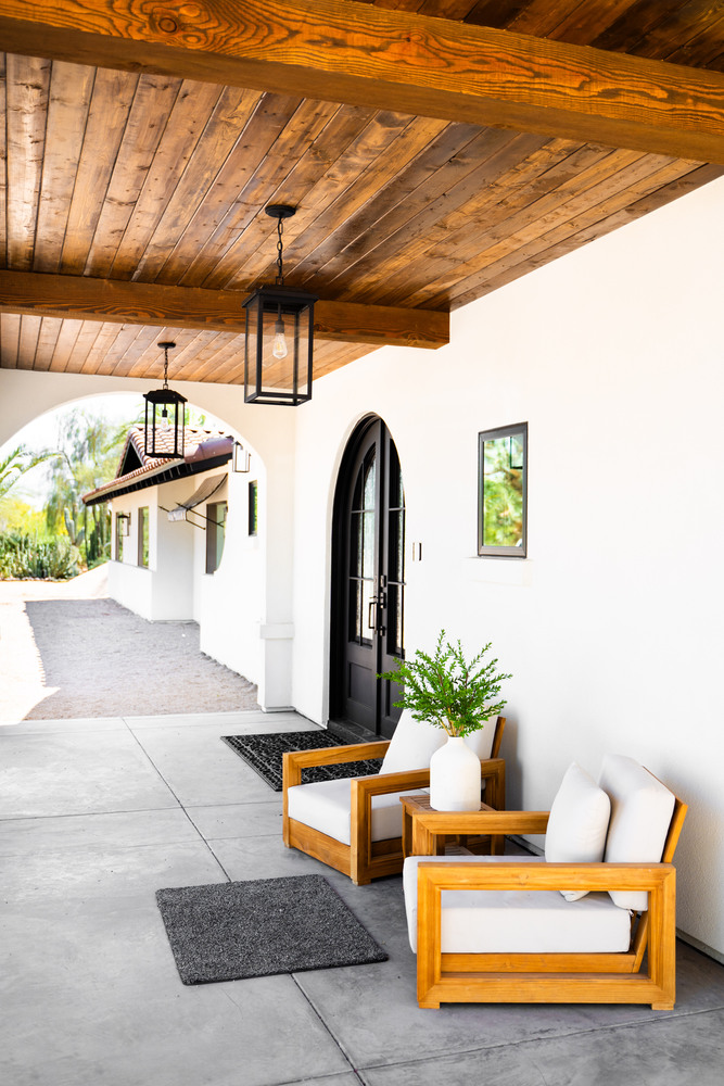 Covered front porch with wood ceiling and modern seating in Scottsdale remodel by Trinity Homes