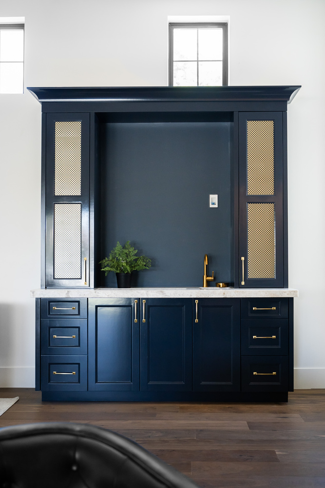 Deep blue custom cabinetry with gold accents in Trinity Homes Scottsdale, AZ renovation