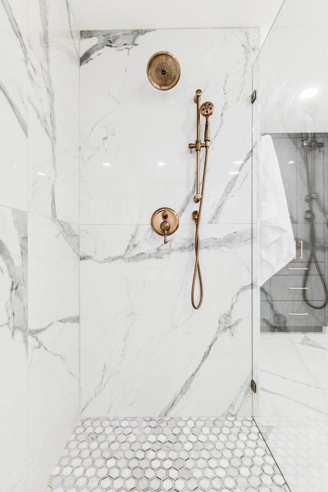 Freestanding tub and herringbone tile floor in Scottsdale bathroom remodel by Trinity Homes
