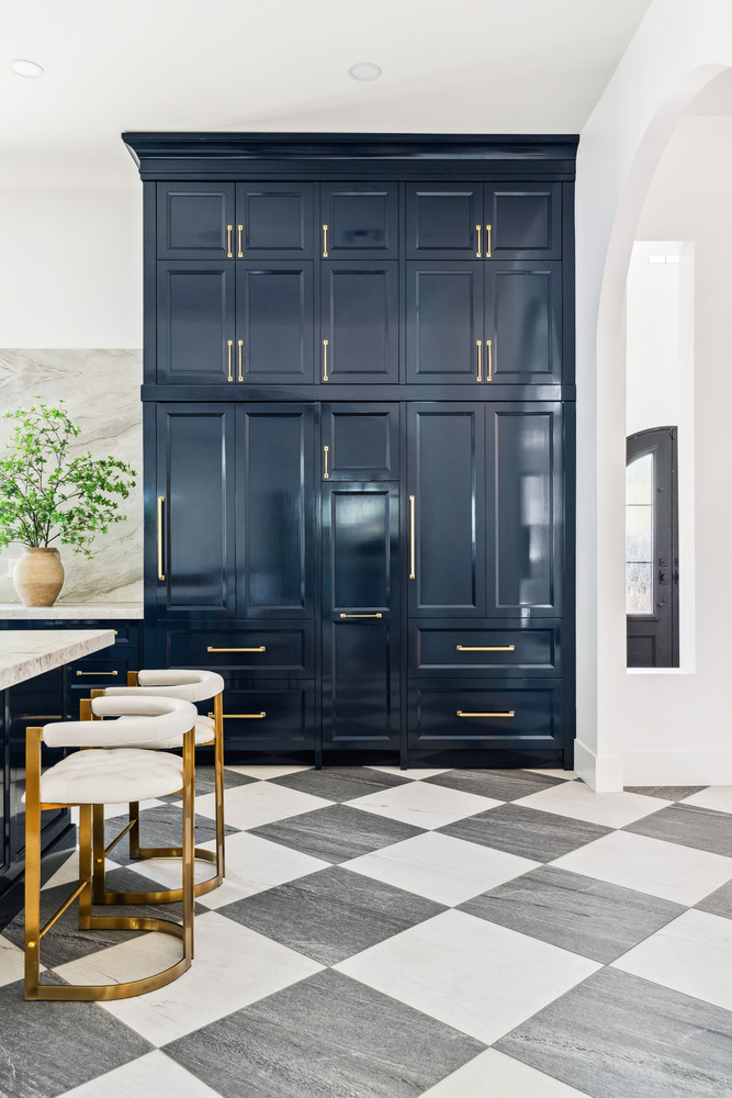 Full-height navy kitchen cabinetry with gold hardware in Scottsdale remodel by Trinity Homes