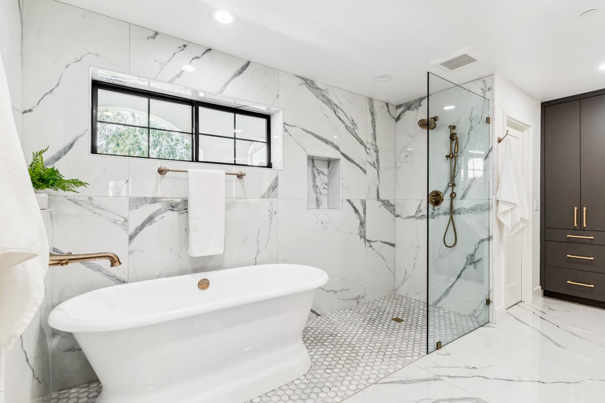 Luxurious bathroom remodel with soaking tub and marble tile by Trinity Homes in Scottsdale AZ