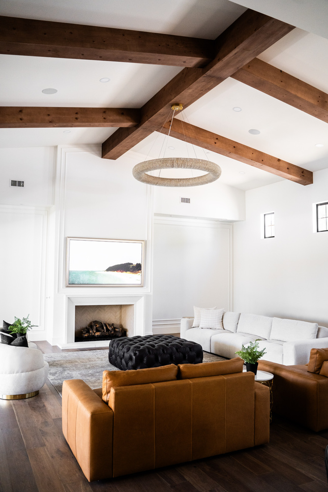 Modern living room with wood beams and fireplace in Trinity Homes’ whole home remodel in Scottsdale, AZ
