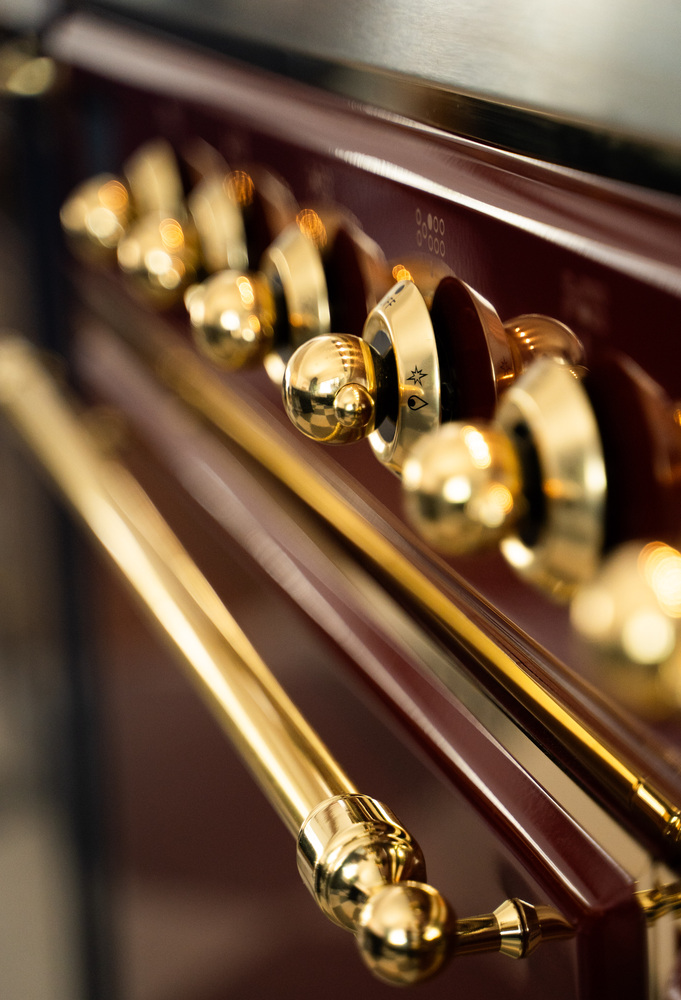 Polished brass stove knobs on luxury range in Trinity Homes Scottsdale, AZ remodel