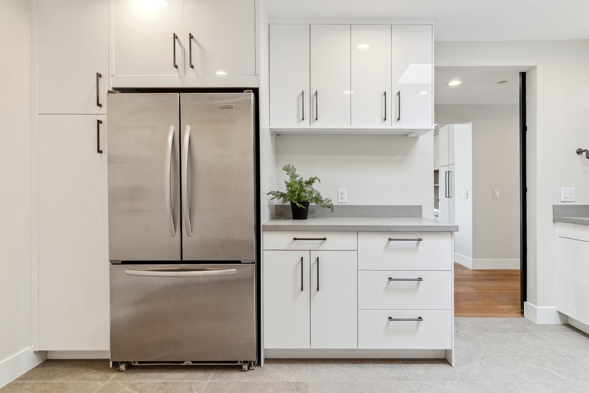 Contemporary laundry room cabinetry with stainless steel fridge by Trinity Homes in Paradise Valley