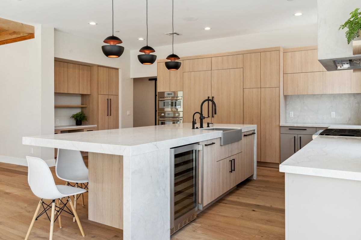 Kitchen remodel with island seating and built-in wine cooler by Trinity Homes in Paradise Valley