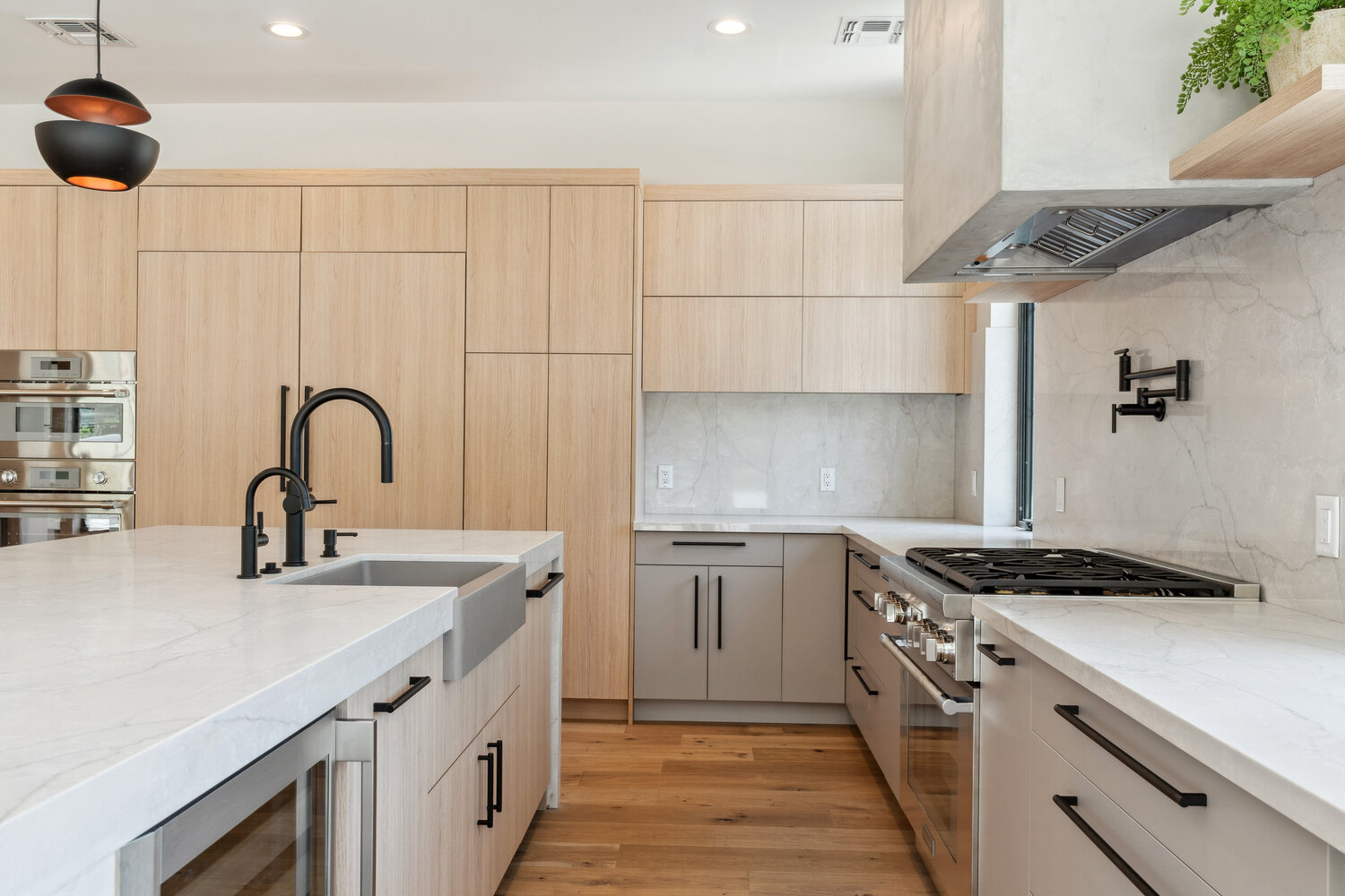 Minimalist kitchen with integrated cabinetry and stainless steel appliances by Trinity Homes in Paradise Valley