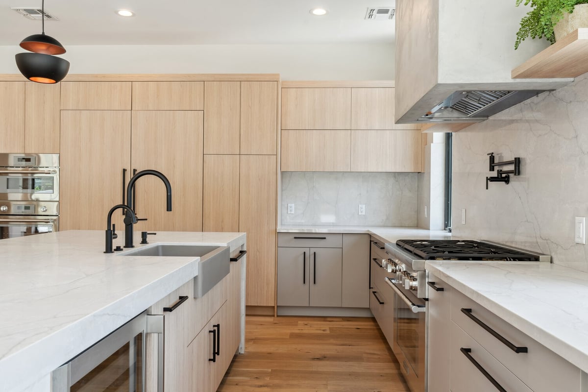 Minimalist kitchen with integrated cabinetry and stainless steel appliances by Trinity Homes in Paradise Valley