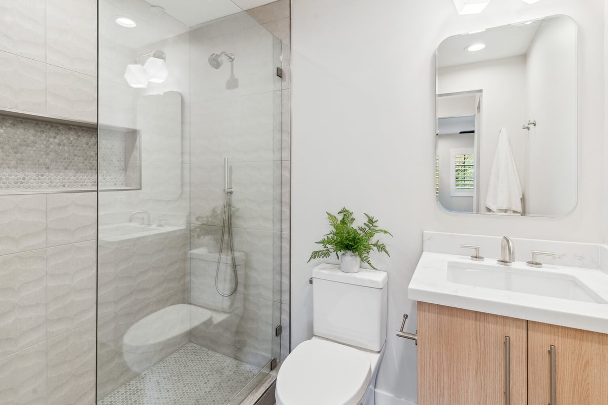 Sleek bathroom remodel with walk-in shower and natural finishes by Trinity Homes in Paradise Valley