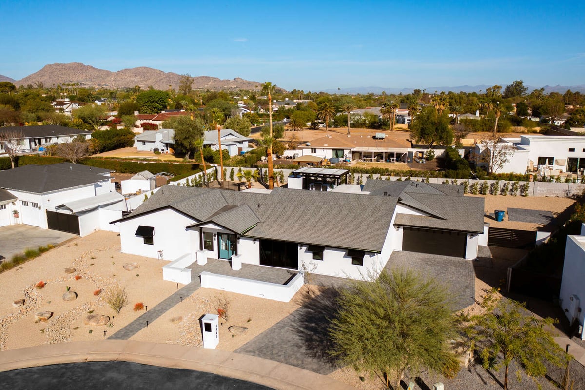 Close-up of entryway with blue double doors and paver path in Scottsdale remodel by Trinity Homes