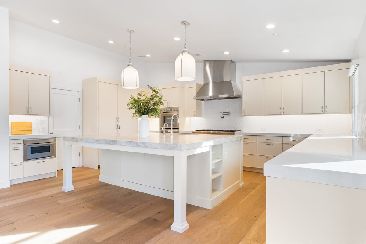 Dual ovens and wide island with prep sink in Trinity Homes kitchen remodel in Scottsdale AZ