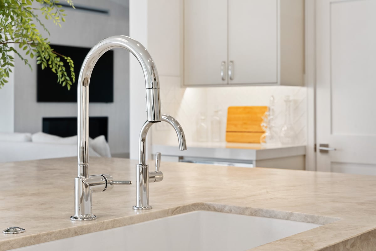 Modern kitchen sink with dual chrome faucets in Scottsdale home remodel by Trinity Homes