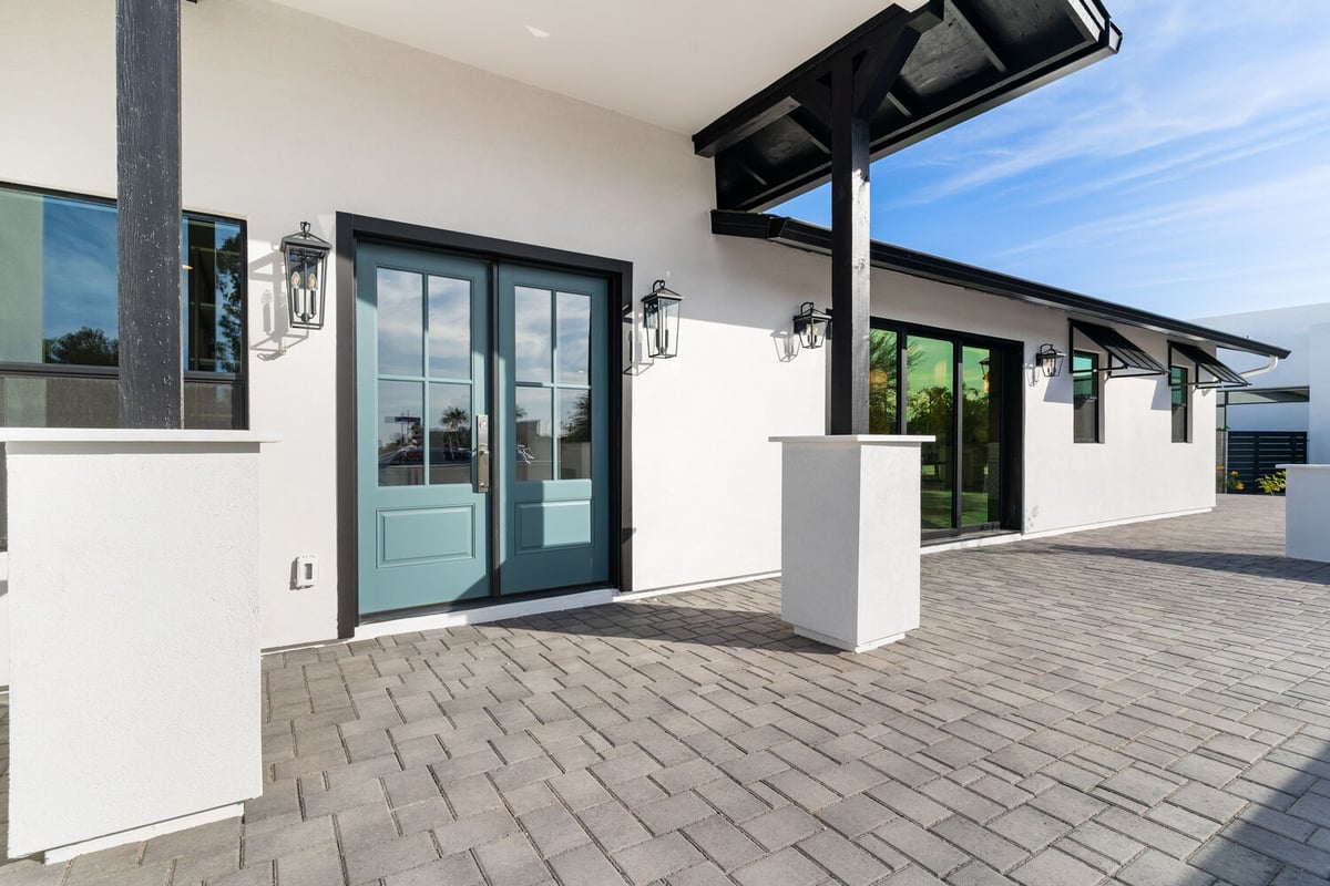 Side view of white modern home with black trim in Scottsdale whole home renovation by Trinity Homes