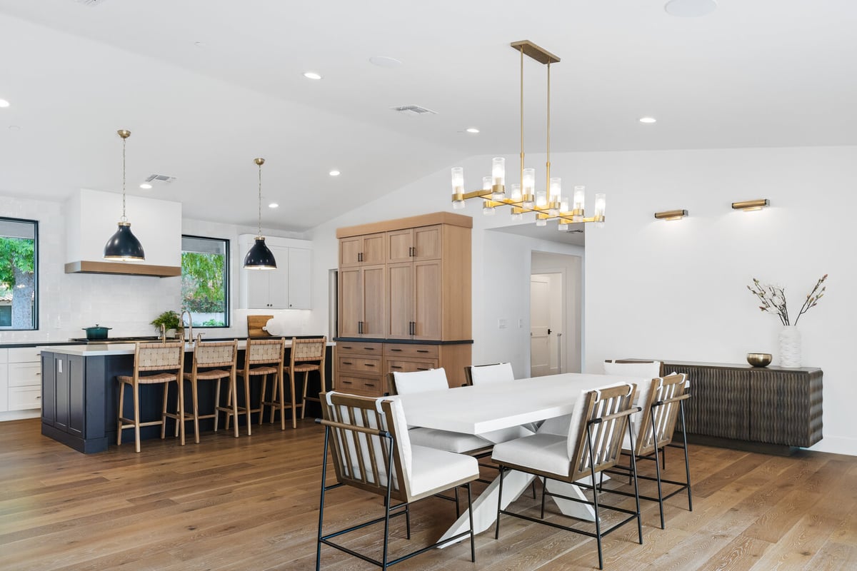 Custom home remodel with two-tone kitchen and formal dining area by Trinity Homes AZ in North Peoria, AZ