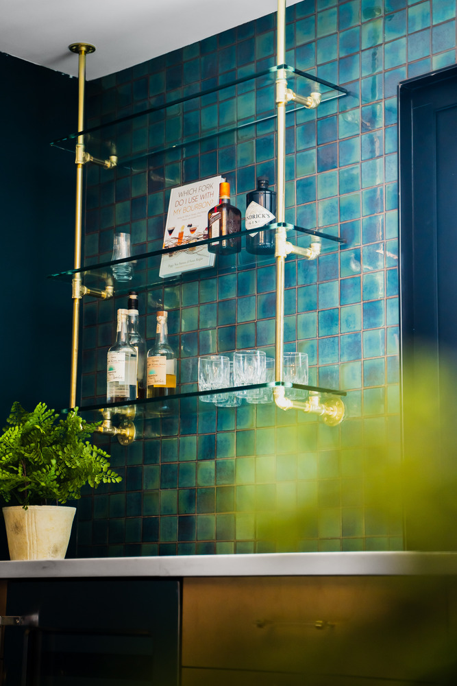 Decorative glass bar shelves with liquor and decor accents in a Phoenix, AZ home by Trinity Homes AZ