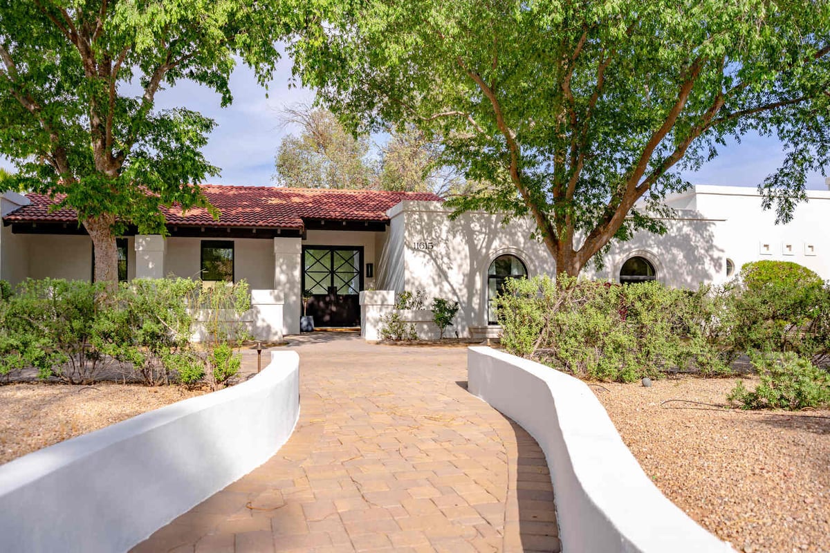 Front view of a custom Spanish-style home with red tile roof by Trinity Homes AZ in Scottsdale, AZ
