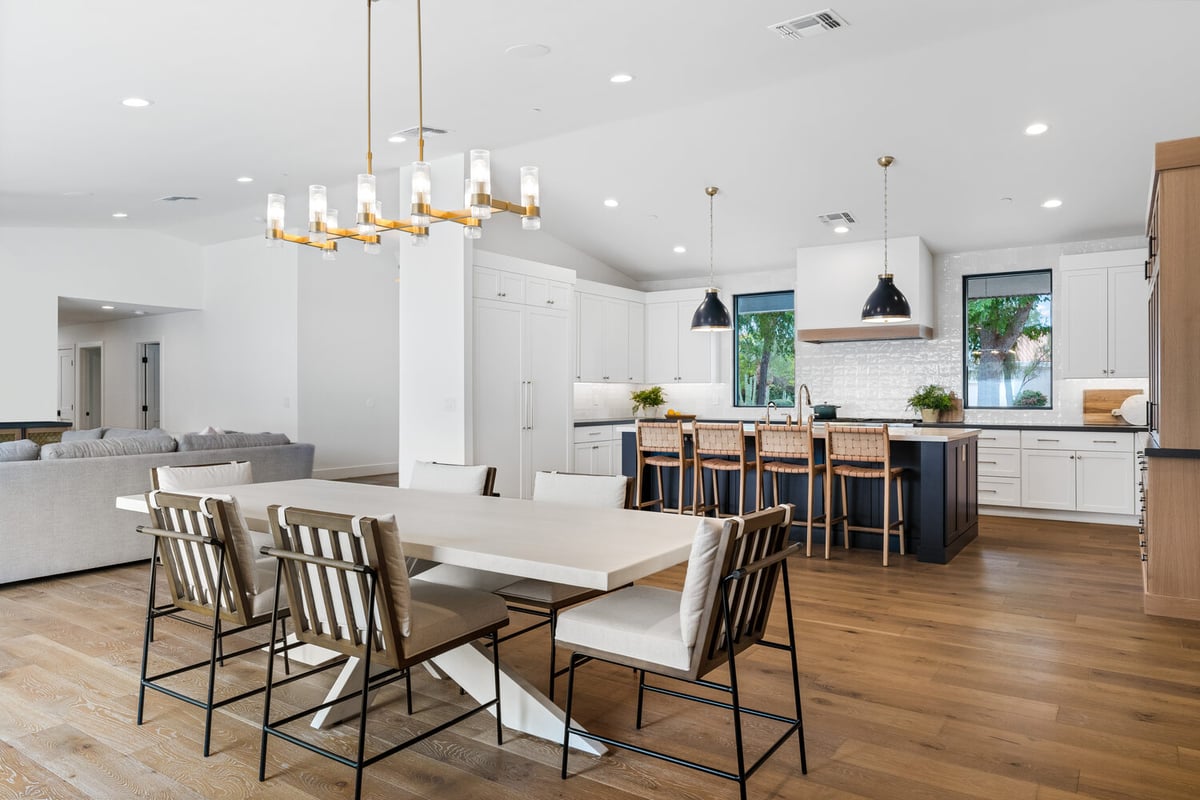 Modern kitchen and dining combo with hardwood floors by Trinity Homes AZ in Glendale, AZ
