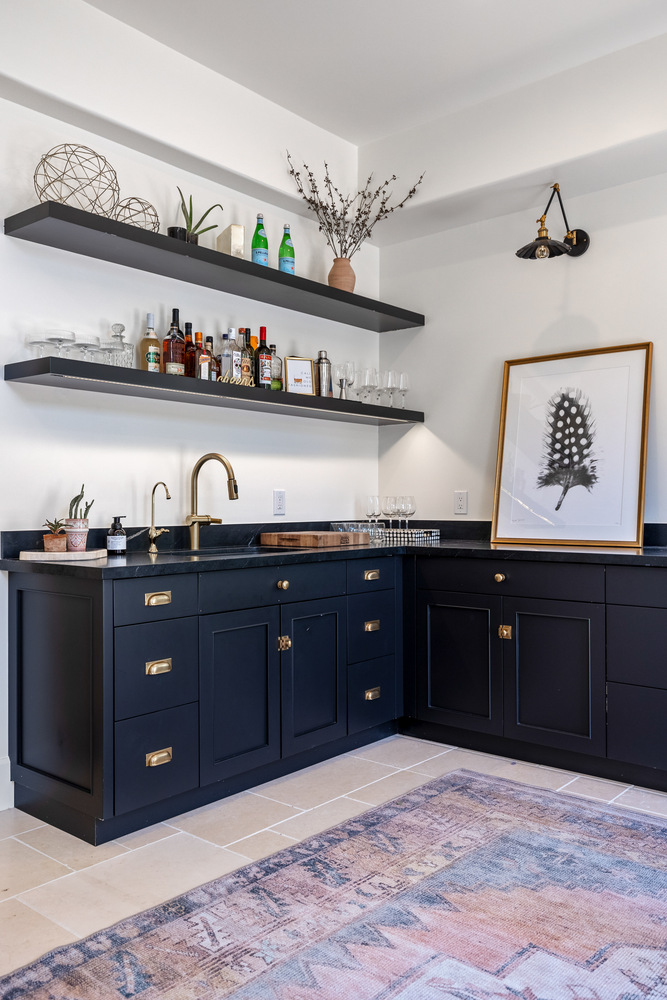 Custom home bar with floating shelves and gold fixtures in a Scottsdale residence by Trinity Homes