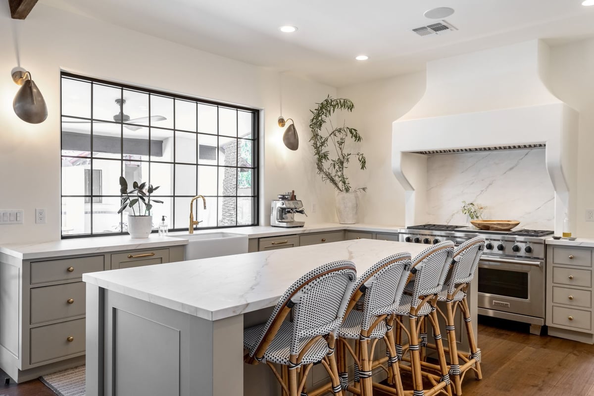 E Appaloosa Kitchenwith wicker island stools, large window and custom range hood by Trinity Homes AZ