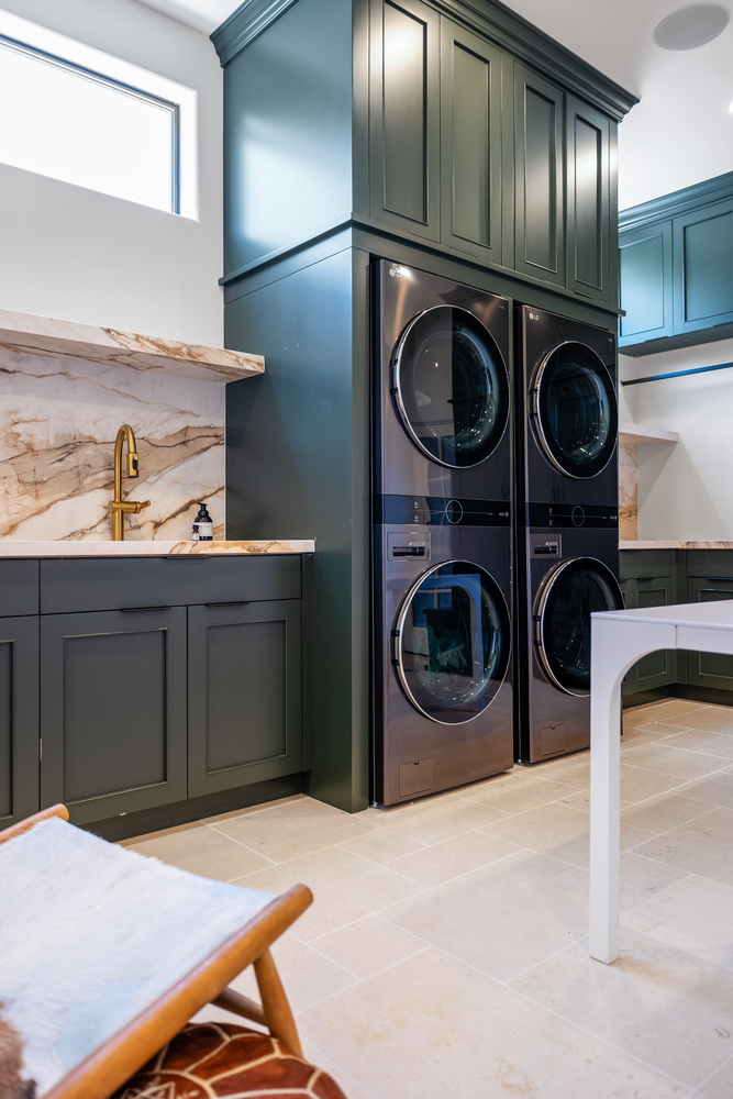 Luxury laundry room with stacked LG washer and dryer units in a Scottsdale custom home by Trinity Homes