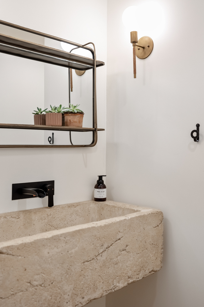 Minimalist bathroom design with organic materials and soft lighting by Trinity Homes in Scottsdale, AZ
