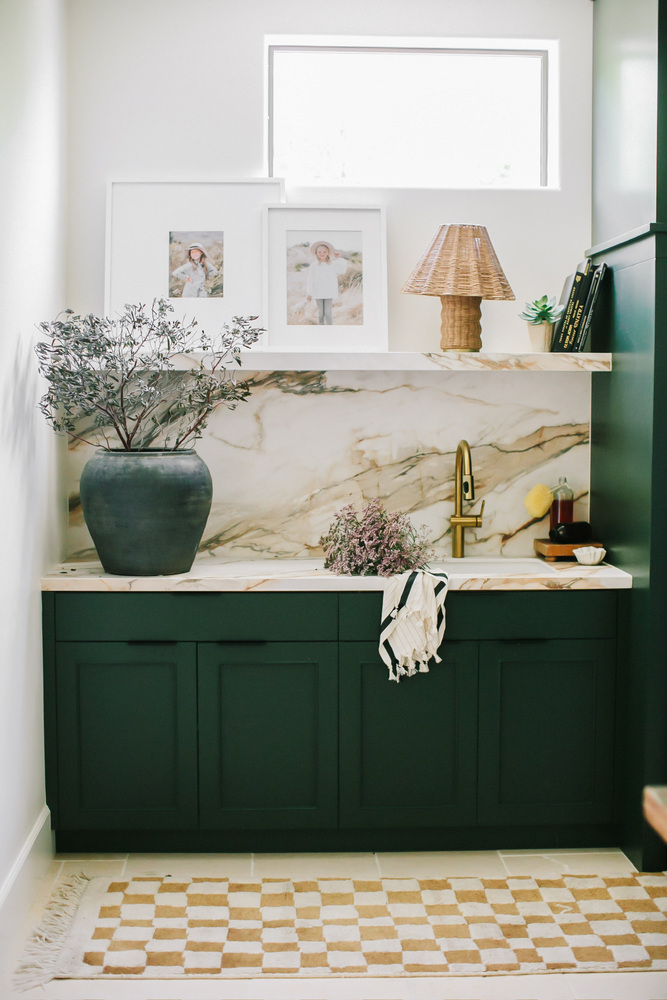 Phoenix whole home remodel by Trinity Homes with dark green cabinets and marble backsplash