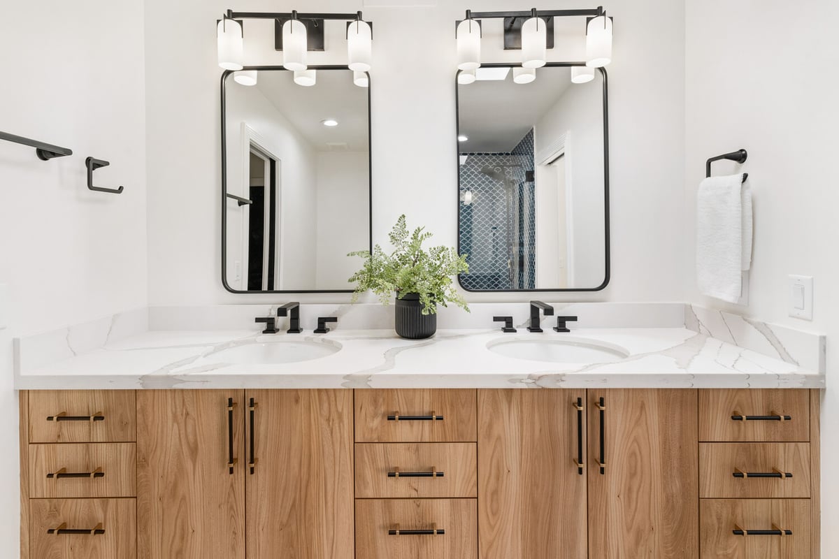 Close-up of double vanity with symmetrical layout and modern light fixtures by Trinity Homes in Scottsdale, AZ