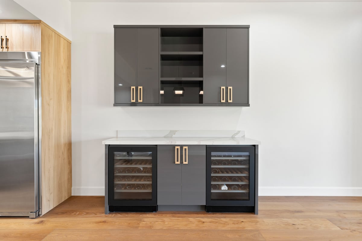 Custom built-in wine storage with glossy cabinetry in Trinity Homes remodel, Scottsdale, AZ