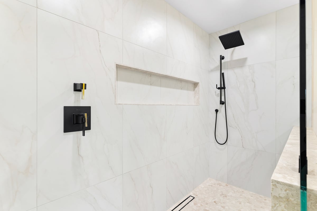 Modern bathroom vanity with dual mirrors and wood cabinetry by Trinity Homes in Scottsdale, AZ