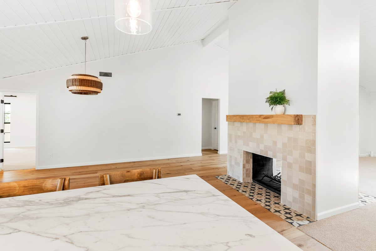 Bright and airy living area featuring modern fireplace design in a Mesa, AZ renovation project by Trinity Homes AZ