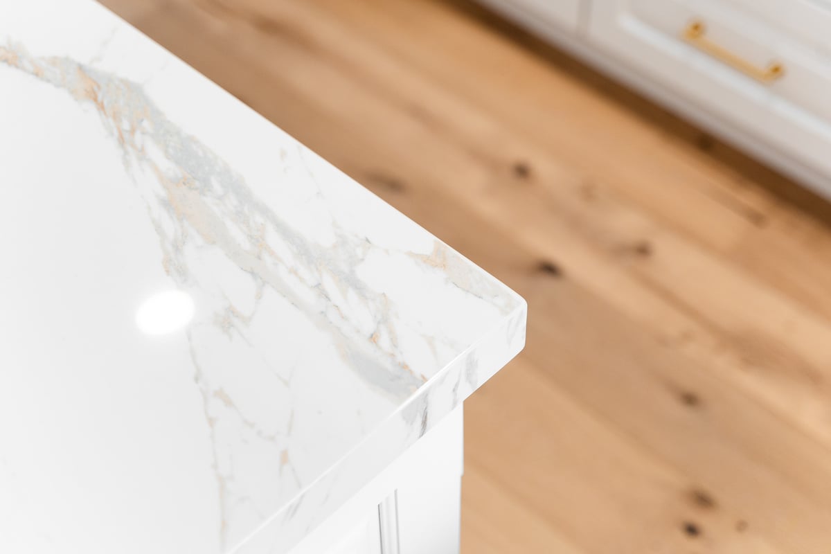 Close-up of waterfall-edge marble kitchen island in a custom home by Trinity Homes AZ in Mesa AZ