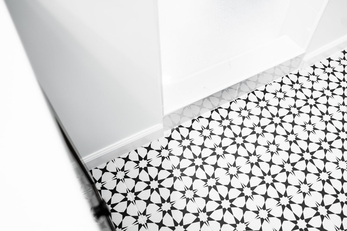Decorative tile detail with sharp geometric contrast in custom bathroom by Trinity Homes AZ in Scottsdale, AZ