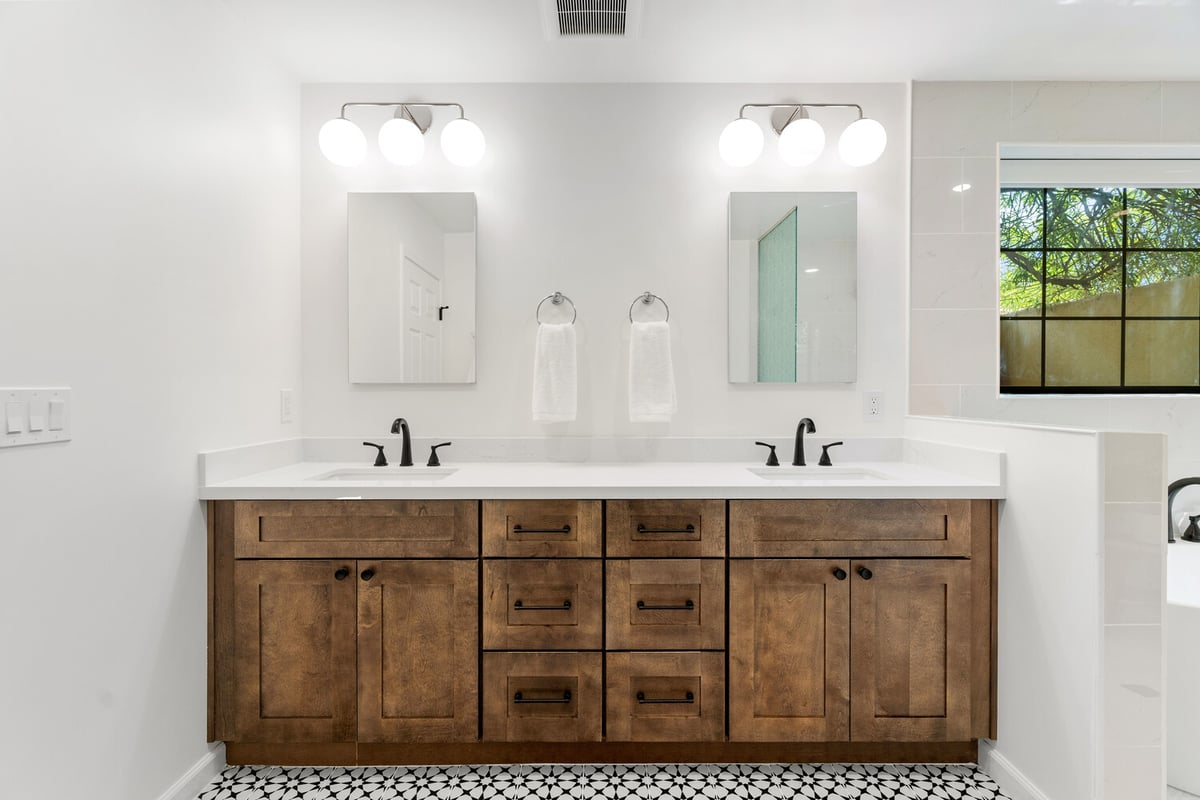 Double vanity with dark wood cabinets and matte black fixtures by Trinity Homes AZ in Cave Creek, AZ