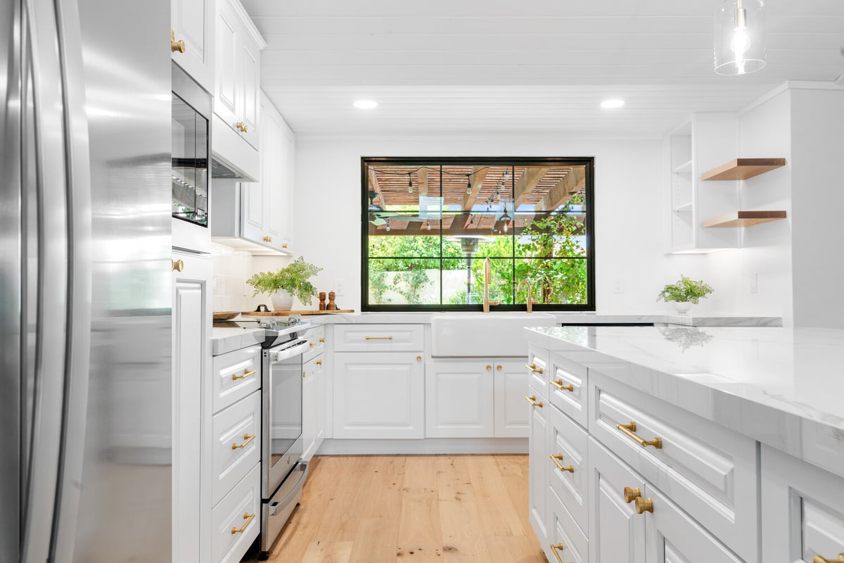 Elegant kitchen design with natural light and bar seating in a Trinity Homes AZ home in Mesa, AZ